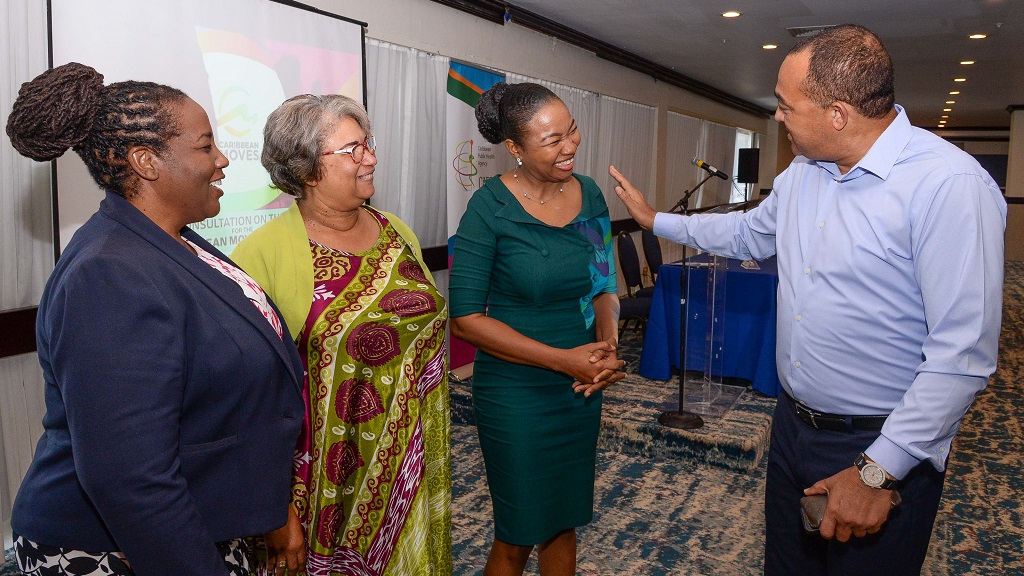 Minister of Health and Wellness, Dr. the Hon. Christopher Tufton (right), interacts with Caribbean Training and Education Centre Executive Director, Dr Natalie Irving-Mattocks (second right), CARPHA) Executive Director, Dr Joy St  John, and CARPHA Head of Chronic Disease and Injury, Dr Heather Armstrong during Tuesday’s opening of the Regional Consultation on the Framework for the Caribbean Moves Initiative, at Jamaica Pegasus hotel in New Kingston. (Photo: JIS)