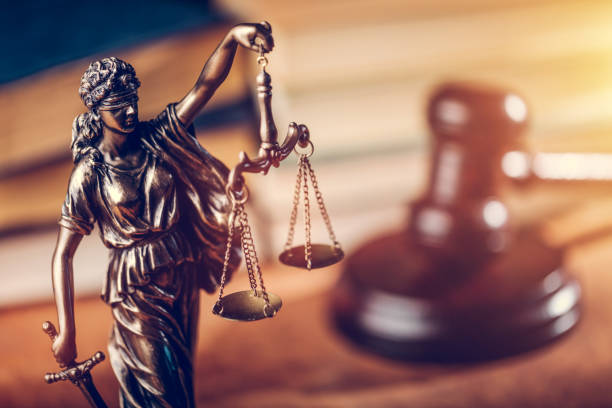 Law concept - statue of Themis, judge's gavel and books.  Photo: iStock