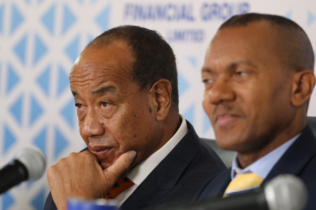 "NCBFG Chairman Michael Lee-Chin (left) at last year's investor briefing, alongside CFO Malcolm Sadler.