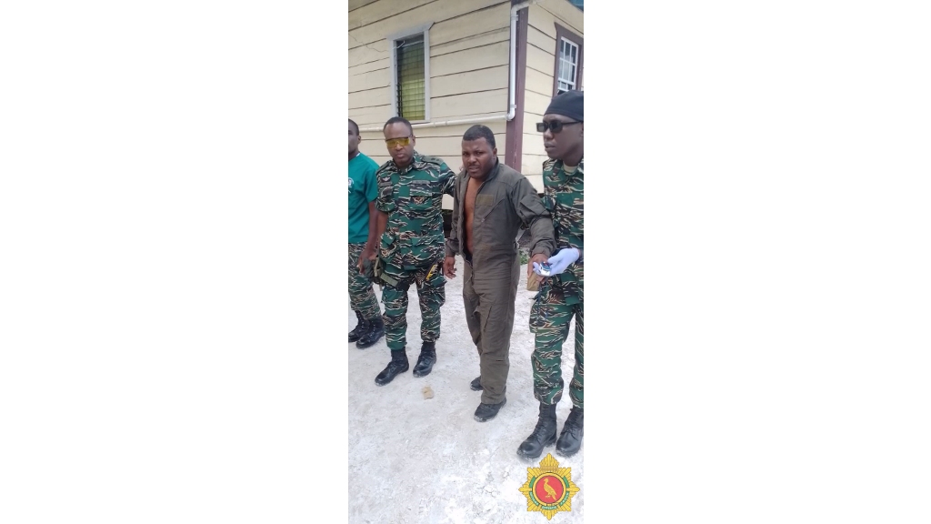 Guyana Defence Force members assist Corporal Dwayne Jackson (centre) after he was rescued from the helicopter crash site. Photo: Guyana Defence Force