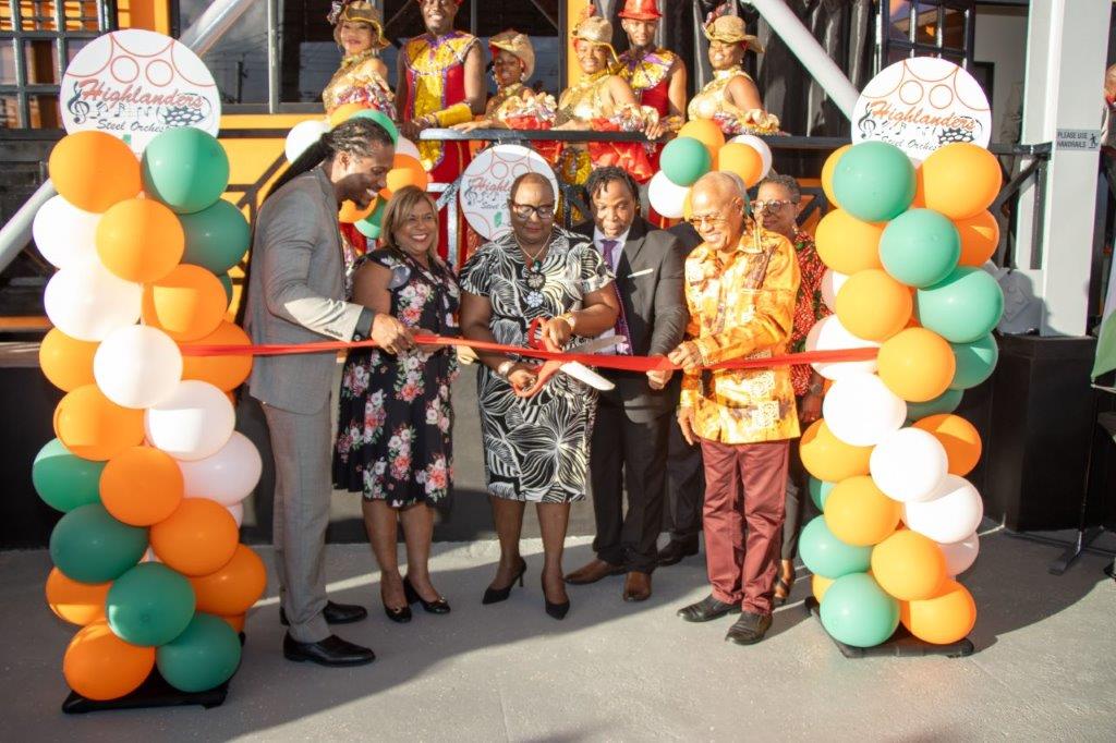 Minister of Housing and Urban Development Camille Robinson-Regis cuts the ribbon at the handing over ceremony for the newly-constructed Highlanders Pan Theatre and Learning Centre.