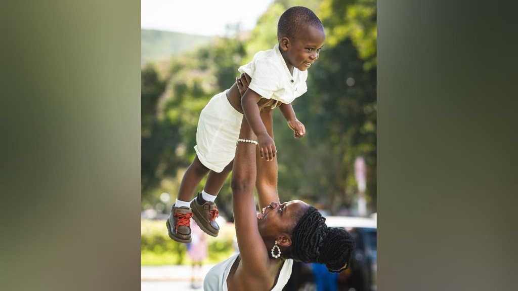 Okheliah Clarke commemorates her college degree with her inspiration, her kid.
