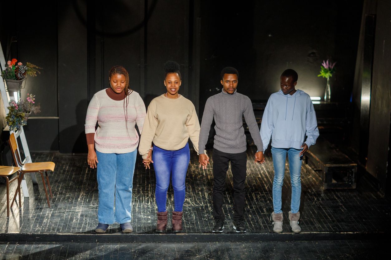A group of young black actors bow to the audience after the play.  Photo: filmstudio/iStock