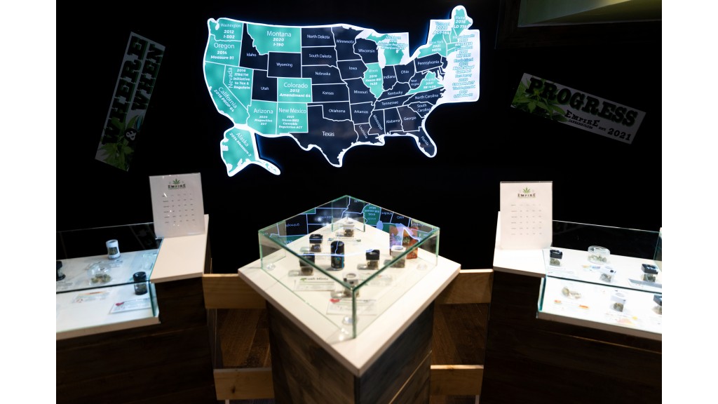 FILE - A map of cannabis legalization in the US glows behind flower displays at the Empire Cannabis Club, November 16, 2022, in New York.  (AP Photo/Julia Nikhinson, File)


