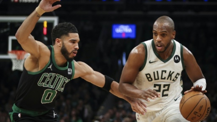 Milwaukee Bucks power forward Khris Middleton (r.) drives to the basket against Boston Celtics power forward Jayson Tatum (l.) during an NBA game between the two franchises at TD Garden from Boston, March 20, 2024 ADAM GLANZMAN / GETTY IMAGES NORTH AMERICA/AFP  
