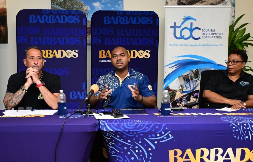 Barbados Tourism Marketing Inc.’s Manager of Sport, Kamal Springer (centre) speaking at the media launch of the Barbados Surf Pro and Live Like Zander events while co-director of Surf Promotion Barbados Limited, Louis Venezia (left) and Tourism Development Corporation Representative, Jacqueline Gill (right) look on. 
