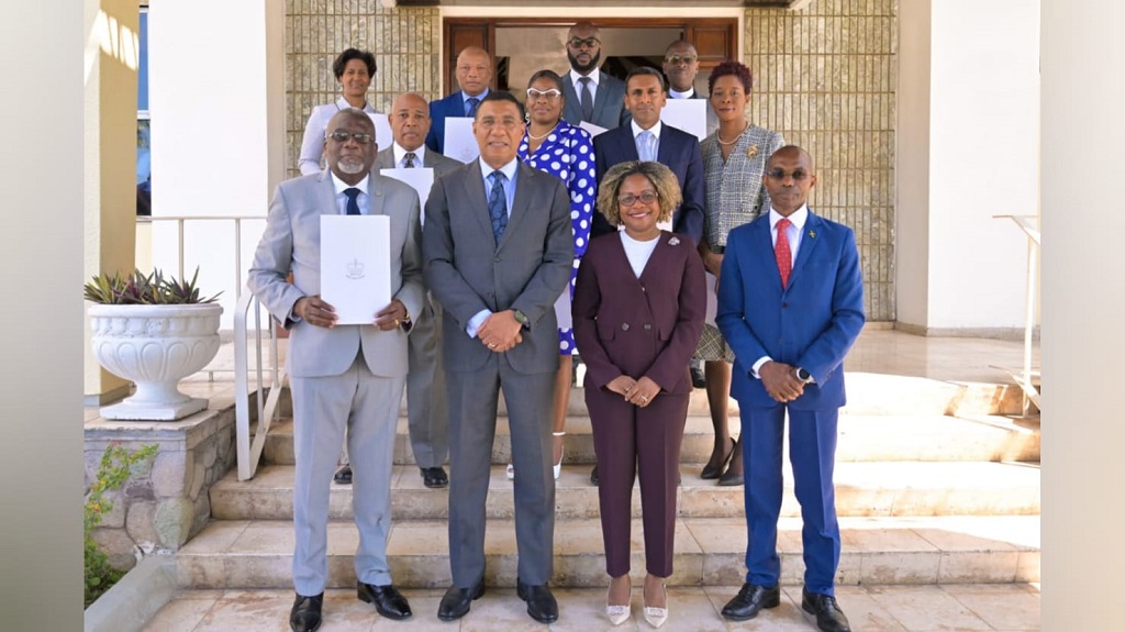 Prime Minister Andrew Holness (front row, second left) with members of the National Identification and Registration Authority and Senator Dr Dana Morris Dixon (front row, second right), minister without portfolio in the Office of the Prime Minister, and Permanent Secretary in the OPM Rocky Meade (front row, right).