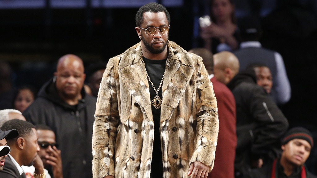 Sean 'Diddy' Combs, wearing a fur coat, walks down the sideline during the second half of an NBA basketball game between the Brooklyn Nets and the New York Knicks, Sunday, March 12, 2017, in New York. (Photo: AP File)