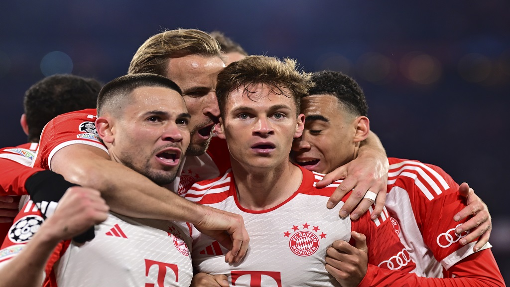 Bayern's Joshua Kimmich, centre, celebrates with teammates after scoring during the Champions League quarter final second leg football match against Arsenal at the Allianz Arena in Munich, Germany, Wednesday, April 17, 2024. (AP Photo/Christian Bruna).