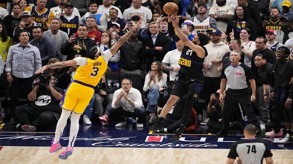 Denver Nuggets guard Jamal Murray (27) hits the game-winning basket against Los Angeles Lakers forward Anthony Davis (3) during the second half in Game 2 of an NBA basketball first-round playoff series Monday, April 22, 2024, in Denver. (AP Photo/Jack Dempsey).