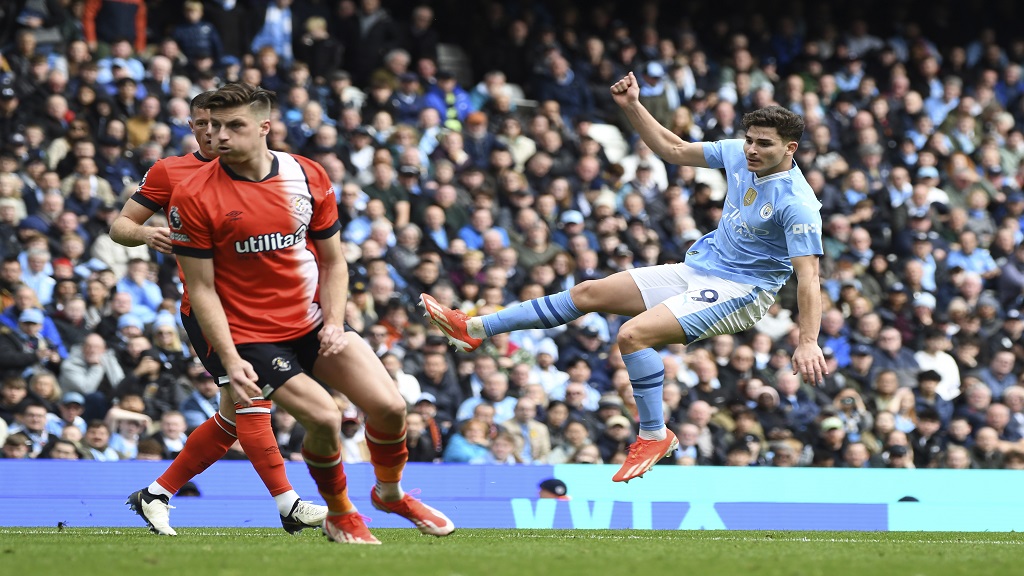 Manchester City's Julian Alvarez, right, makes an attempt to score during the English Premier League football match against Luton Town at Etihad stadium in Manchester, England, Saturday, April 13, 2024. (AP Photo/Rui Vieira).