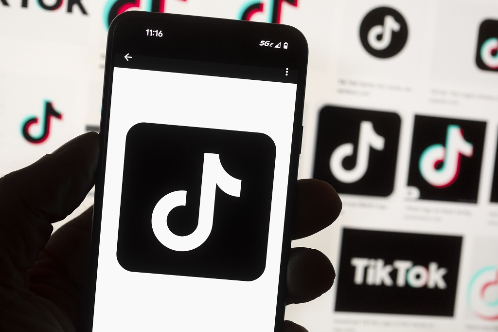  FILE - The TikTok logo is displayed on a mobile phone in front of a computer screen, October 14, 2022, in Boston. A measure set to force TikTok's parent company to sell the video-sharing platform or face a ban in the US received President Joe Biden's official sign-off on Wednesday, April 24, 2024. But the newly-minted law could soon face an uphill battle in court. (AP Photo/Michael Dwyer, File)