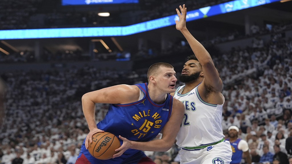  Denver Nuggets center Nikola Jokic (15) works toward the basket as Minnesota Timberwolves center Karl-Anthony Towns defends during the first half of Game 6 of an NBA basketball second-round playoff series Thursday, May 16, 2024, in Minneapolis. (AP Photo/Abbie Parr).