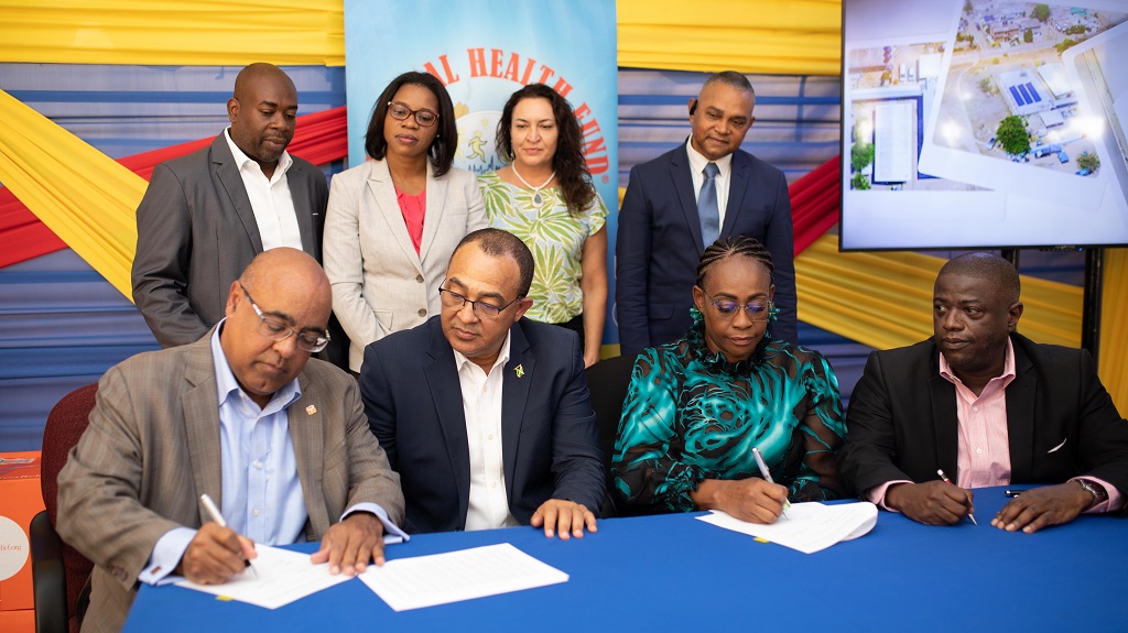 Direct Relief’s Dr Byron Scott (left) and NHF’s CEO Everton Anderson [right] signed an MOU for humanitarian assistance to Jamaica. Dr Christopher Tufton, MP (2nd left] and Juliet Holness, MP (2nd right) witnessed the signing. Standing (from left) are the NHF’s Richard Allen, Grace-Ann Johnson, Genevieve Bitter, and Michael Stern.