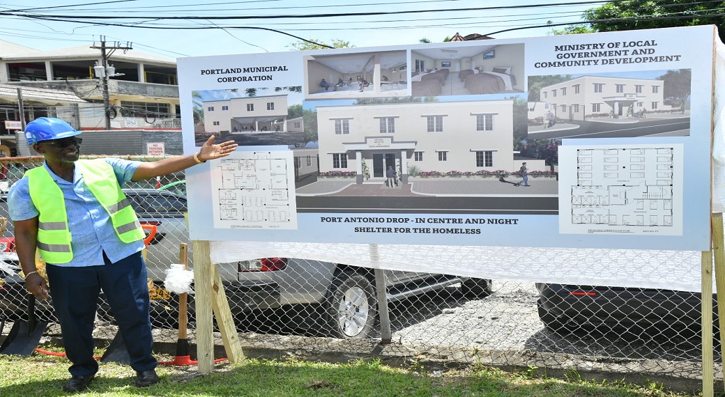 Minister of Local Government and Community Development, Desmond McKenzie displays plans for the Portland Night Shelter and Drop-in Centre, during the recent groundbreaking ceremony held at the Poor Relief Office in Port Antonio.
