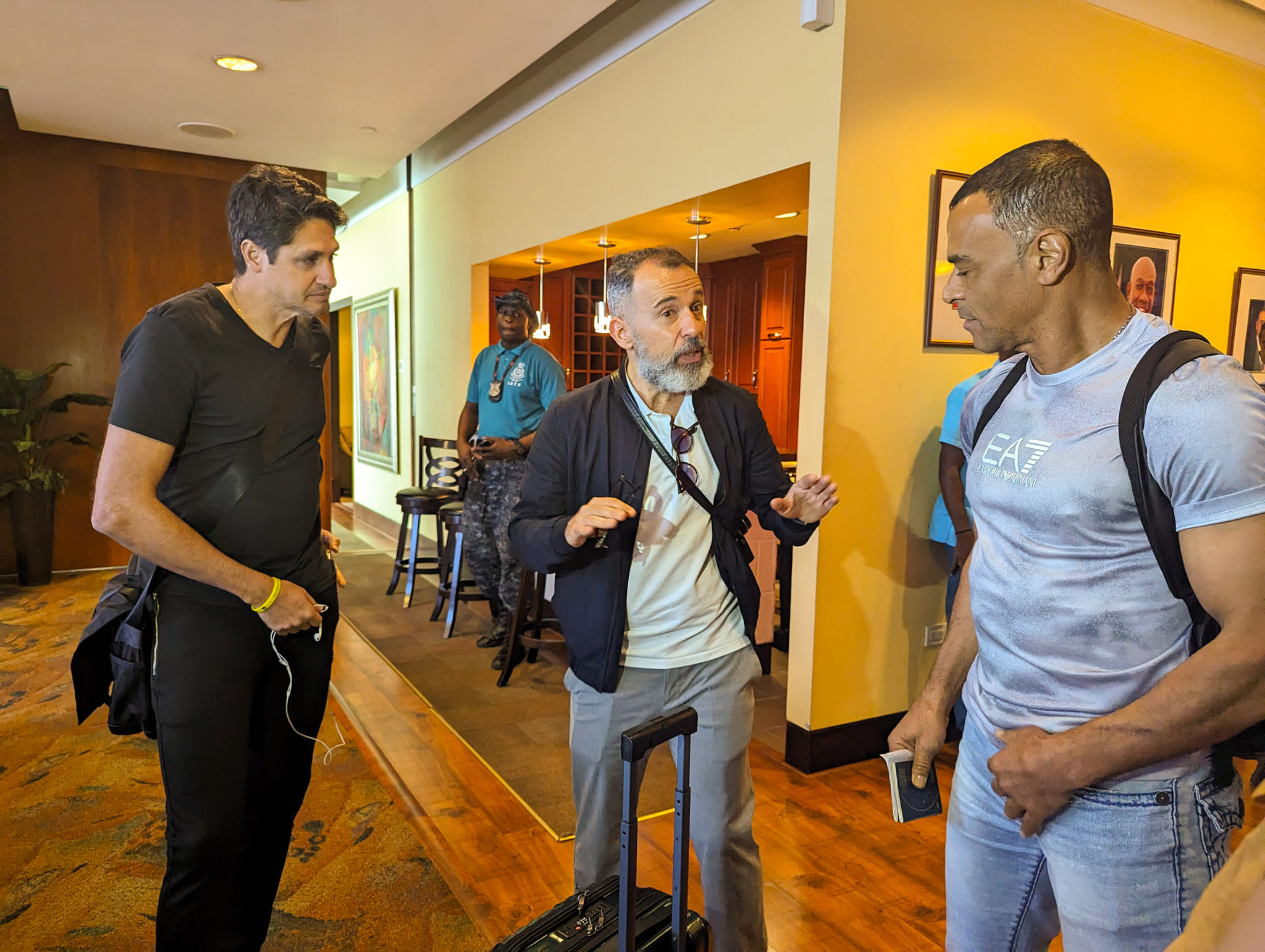 Former Brazil stars Edmilson (left) and Cafu (right) speak to an unidentified man at the VIP Lounge of the Piarco International Airport. (Photo credit - TTFA Media)