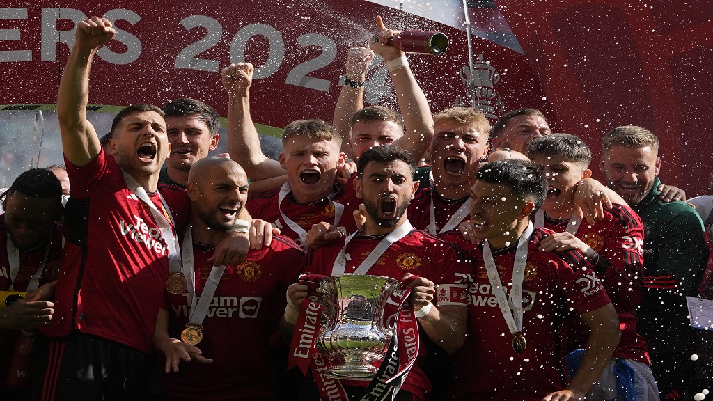 Manchester United's Bruno Fernandes holds the trophy after his team won the English FA Cup final football match against Manchester City at Wembley Stadium in London, Saturday, May 25, 2024. Manchester United won 2-1. (AP Photo/Kin Cheung).