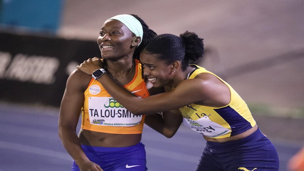 Ivory Coast's Marie-Josee Ta Lou-Smith (left) and Jamaica's Krystal Sloley celebrate after the women's 100m at the inaugural Jamaica Athletics Invitational at the National Stadium on Saturday, May 11, 2024. (PHOTO: Marlon Reid).