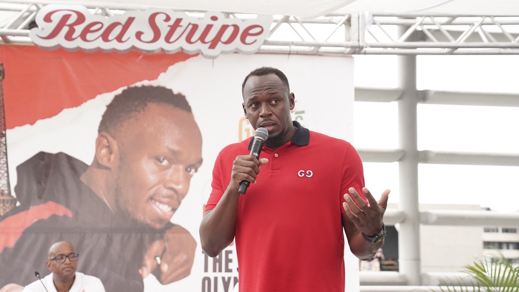 Sprint legend Usain Bolt speaking Wednesday at the launch of Red Stripe's 'Guh Fi Gold and Glory' Olympics campaign at the Half-Way Tree Transport Centre in St Andrew.