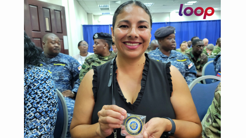 US Army South Rosie Sandoval  - Army South Co-lead, shows off her commemorative challenge coin presented by US Ambassador Roger F Nyhus at the TW24 closing ceremony in Barbados on May 16, 2024.