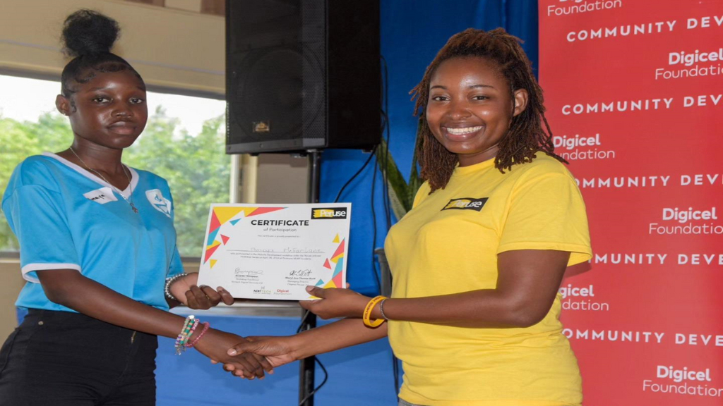 Sheryl-Ann Thomas-Scott presents a certificate to a participant from Cumberland High. (Photo:Mahado Thomas)