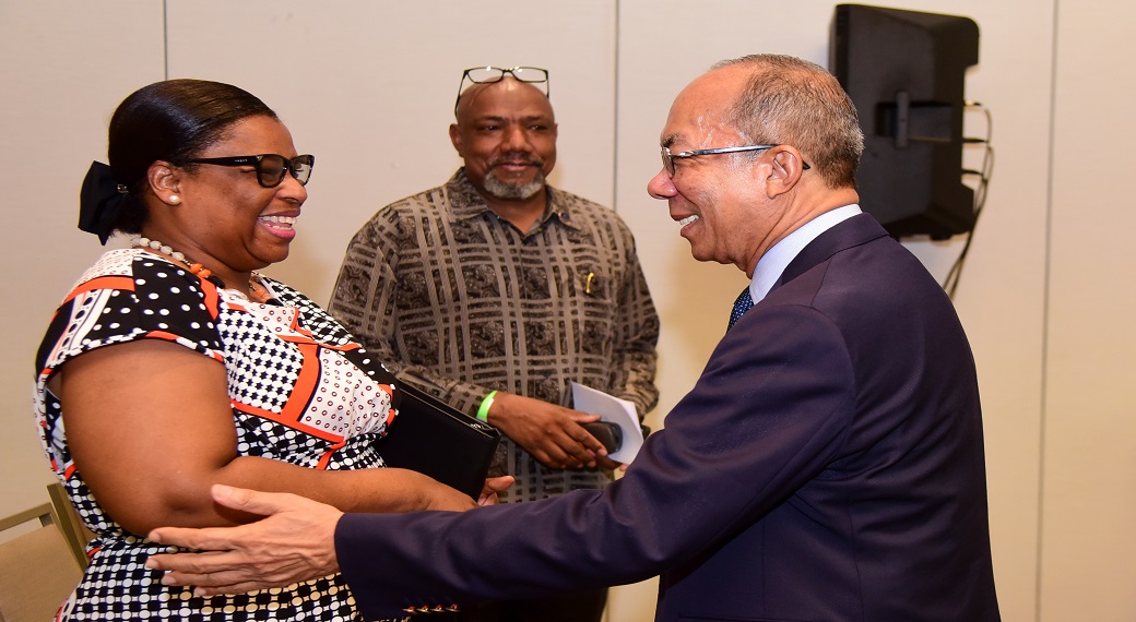 Deputy Prime Minister and Minister of National Security, Dr Horace Chang (right), greets Executive Director, Institute of Forensic Science and Legal Medicine, Dr Judith Mowatt (left), at the Caribbean Association of Forensic Sciences (CAFS) Conference. At centre is Head of the Department of Basic Medical Sciences and Professor of Molecular Biology, University of the West Indies, Mona, Professor Paul Brown.
