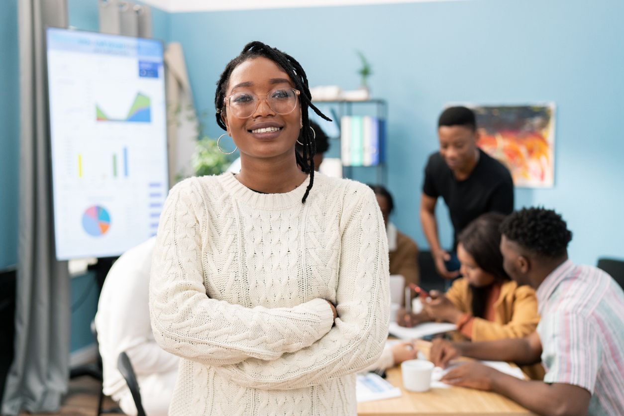 A young woman smiling for a photo taken in the office.  Photo: iStock