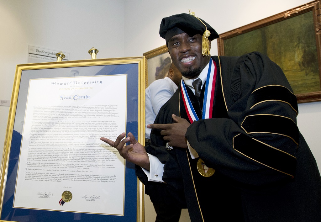 FILE - Artist and entrepreneur Sean Combs poses next to his honorary Doctor of Humanities degree during the Howard University graduation ceremony in Washington, Saturday, May 10, 2014. In a ruling, Friday, June 7 2024, Howard University cuts ties with Combs, rescinding the honorary degree awarded to him and dissolving a scholarship program in his name.  (AP Photo/Jose Luis Magana, File)