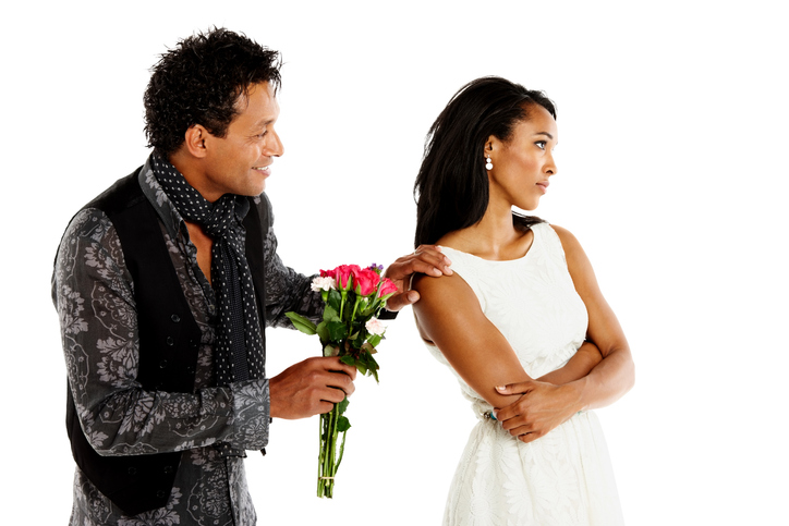 A man trying to get back together with his ex-girlfriend gives her flowers.  Photo: iStock. 