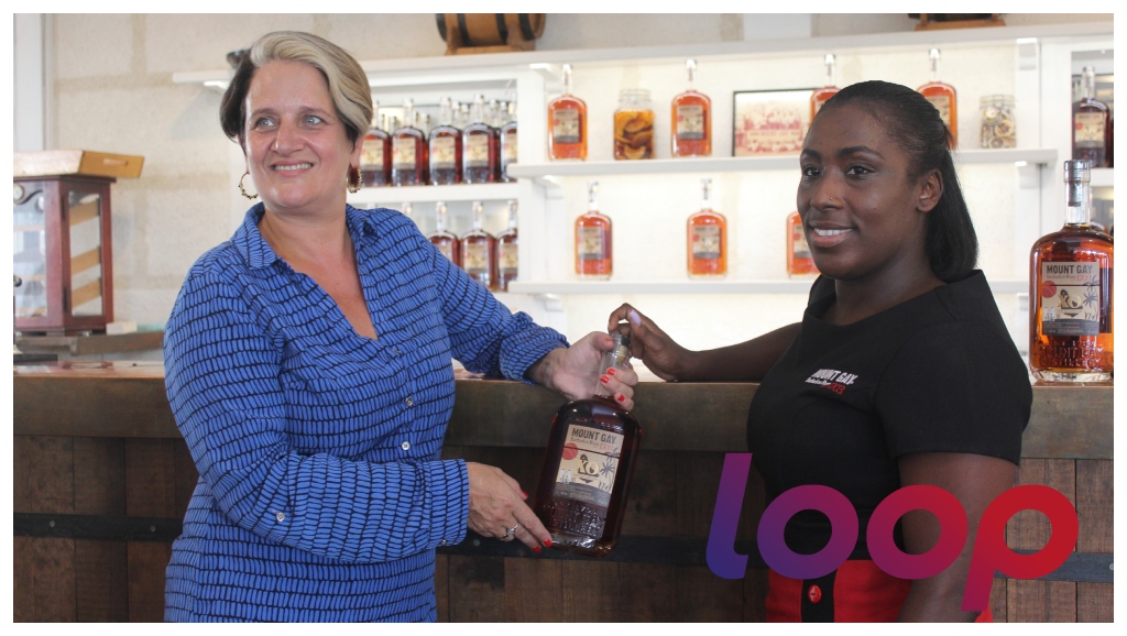 Commercial Manager for Mount Gay, Anies Jordan and Tours Experience Supervisor at the Mount Gay Visitors’ Centre Tina Forde showing the Limited Edition XO cricket-inspired label