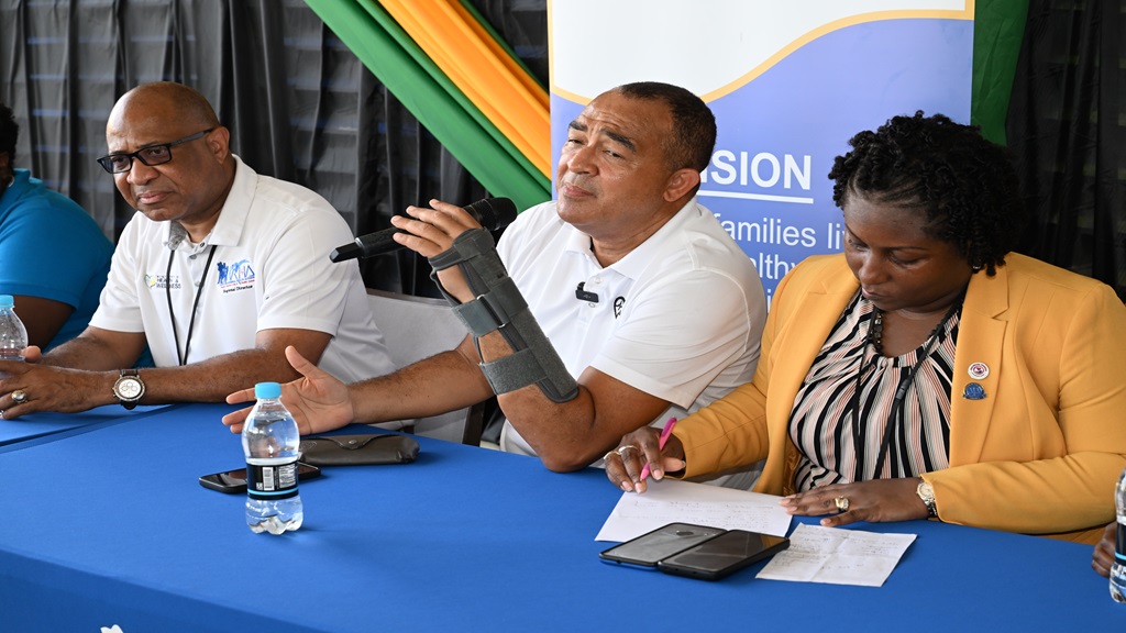 Minister of Health and Wellness, Dr Christopher Tufton (centre), addresses a vector control team in Trelawny at the Falmouth Public General Hospital on Friday, July 26. With him are Parish Manager of the Trelawny Health Services, Keriesa Bell Cummings, and Regional Director of the Western Regional Health Authority (WRHA), Andrade Sinclair. (photo: JIS)