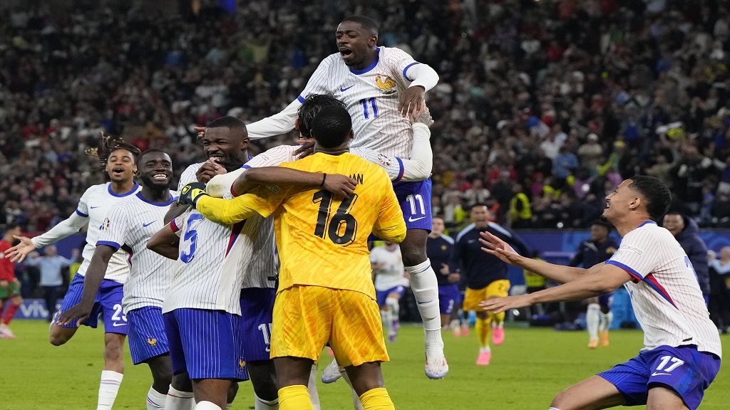 France players celebrate after penalty shootout against Portugal during a quarter final match at the Euro 2024 football tournament in Hamburg, Germany, Friday, July 5, 2024. (AP Photo/Hassan Ammar).