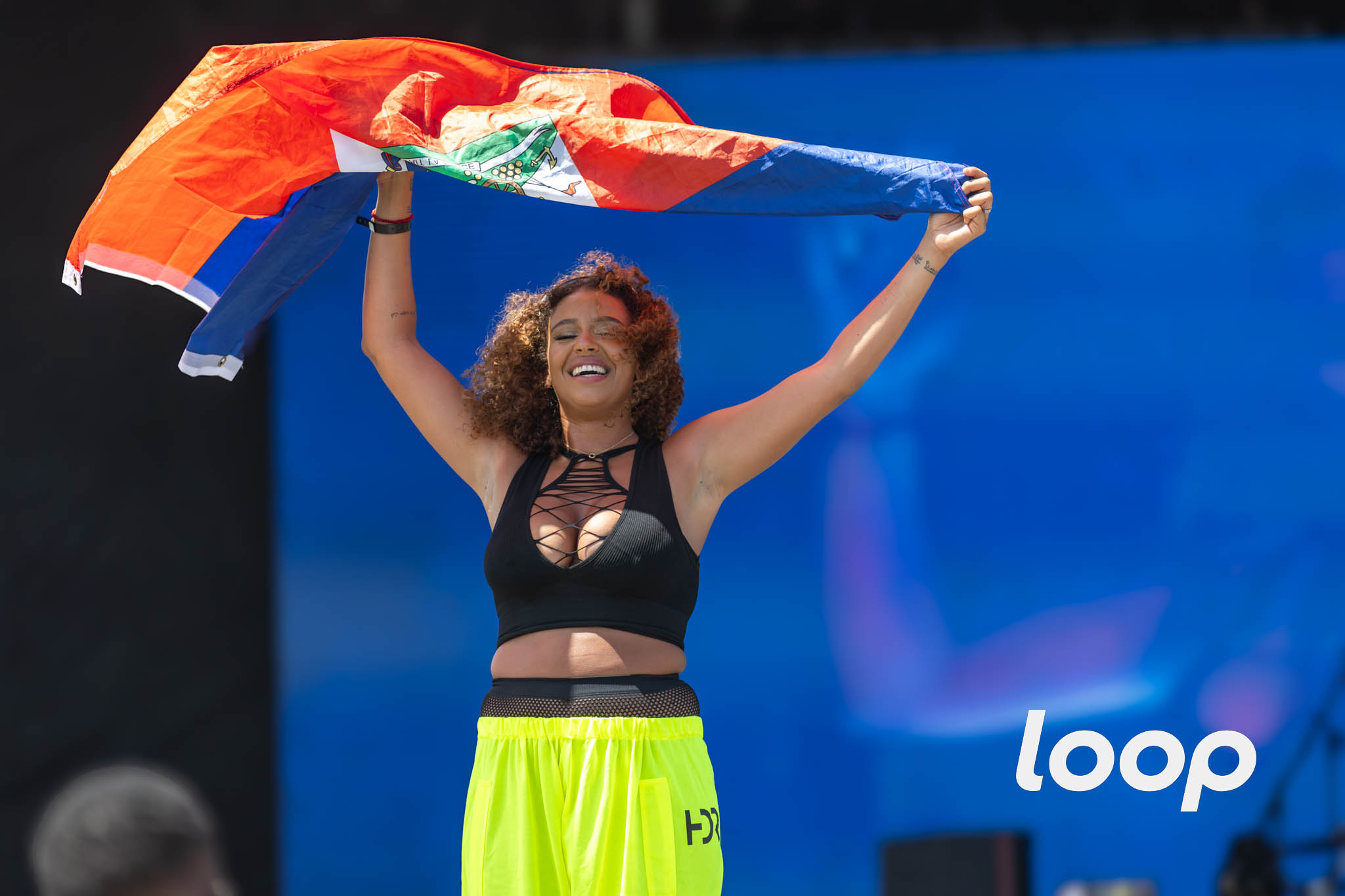 Singer Kanis on stage at Sumfest with the Haitian flag, July 7, 2024. Photo: John Wall Marc Henley Augustin