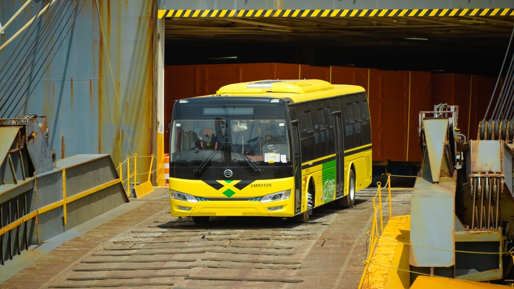 Newly arrived buses for the state-operated public transportation service being offloaded from a cargo ship at Kingston Wharves on Monday.