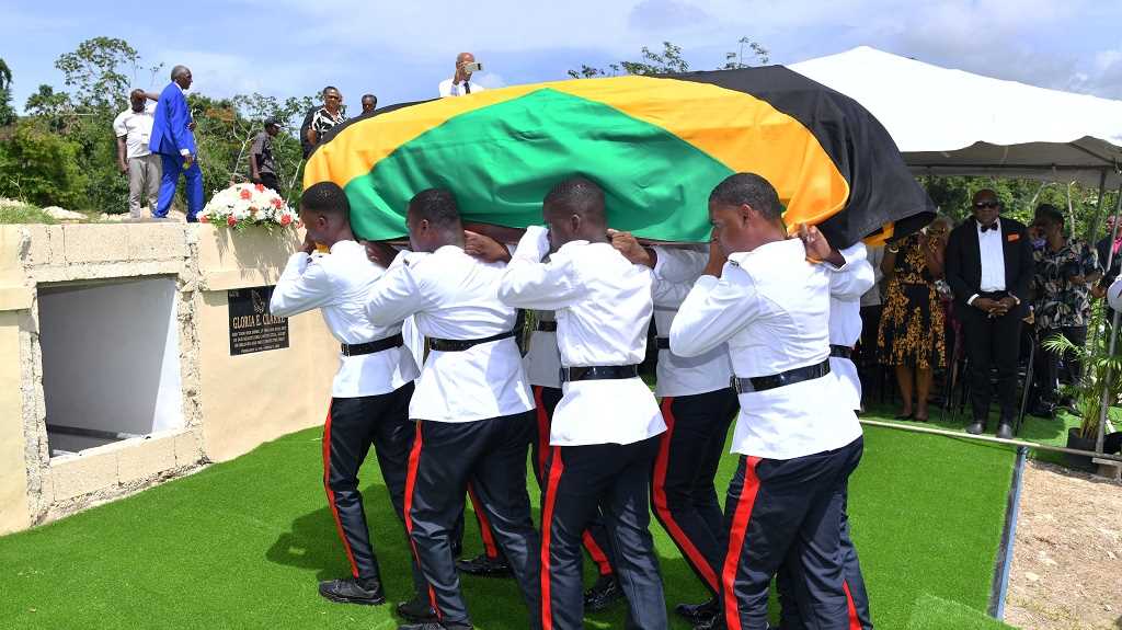 Members of the Jamaica Constabulary Force (JCF) carry the body of former Speaker of the House of Representatives Violet Neilson to a sepulcre at Dovecot Memorial Park in St James, following the funeral service  at the  Montego Bay Convention Centre in the parish, on July 8. (Photo: JIS)