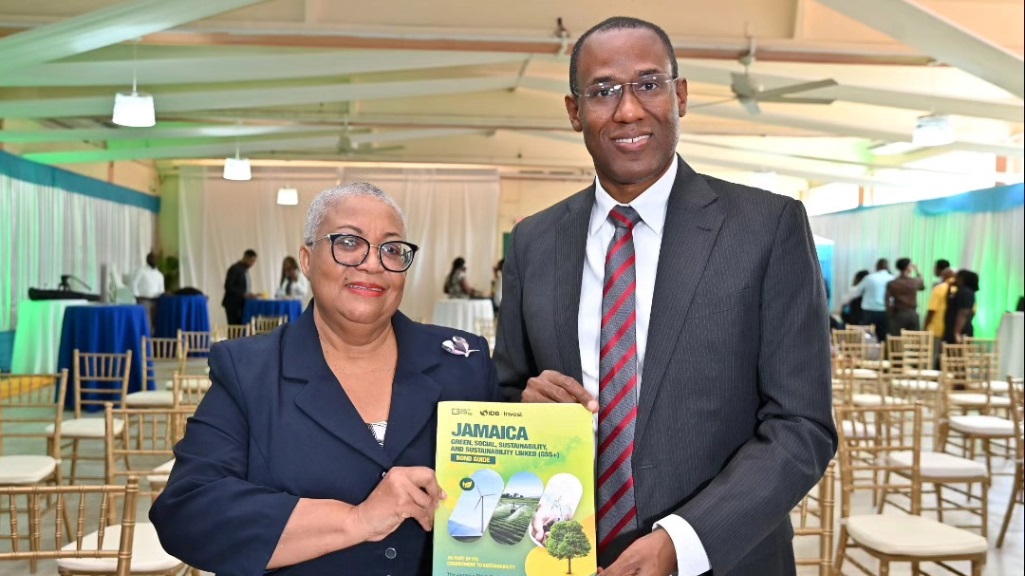 Managing Director of the Jamaica Stock Exchange Dr Marlene Street-Forrest (left) and Dr Nigel Clarke, Jamaica's Minister of Finance share a photo with the he Green, Social, Sustainability and Sustainability-Linked Bond Guide that developed with the support of IDB Invest and other local and international partners.