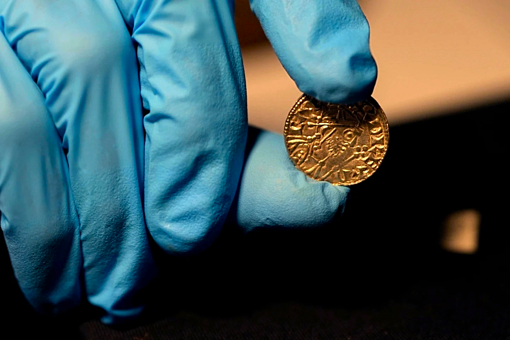 An Edward the Confessor Pyramid coin (1065-6), part of the Chew Valley Hoard of 2,584 coins, buried in the turmoil following the Norman Invasion of Britain in 1066, is on display at the British Museum in London. The hoard is valued at £4.3m, (US$5.58m), a record find. (Photo: AP/Alastair Grant)