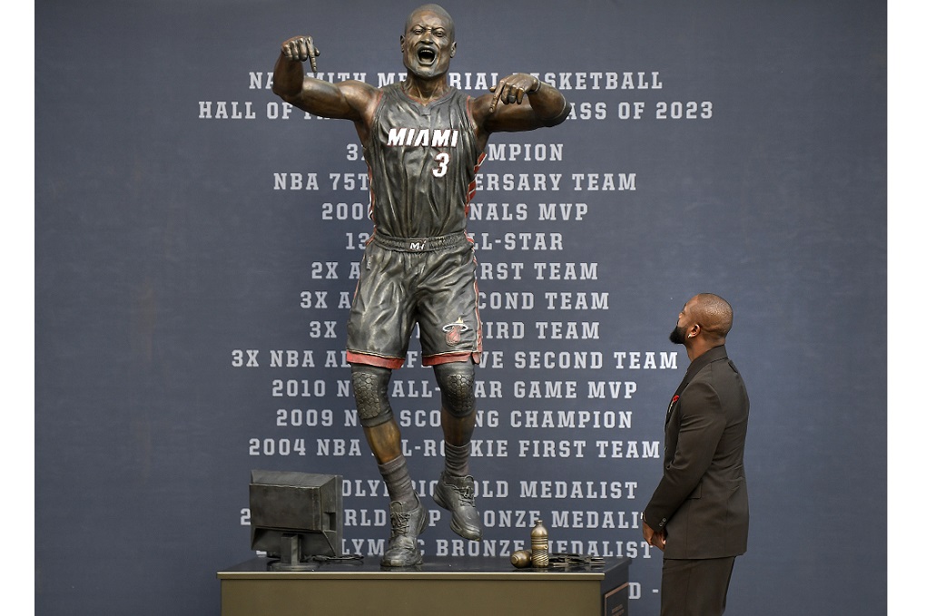 Former Miami Heat NBA basketball player Dwyane Wade looks at a bronze statue in his image during its unveiling ceremony outside Kaseya Center, Sunday, October 27, 2024, in Miami, Fla. (AP Photo/Michael Laughlin)