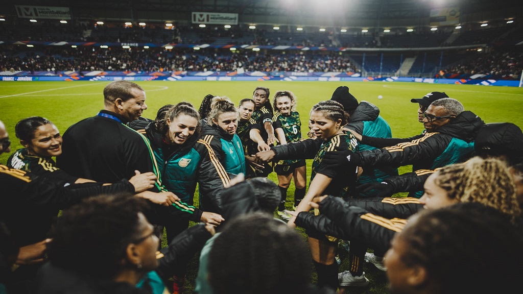 Reggae Girlz head coach Hubert Busby (left) with his team after their international friendly against France at Stade Auguste-Bonal on Friday, October 25, 2024. (PHOTO: JFF social media page).