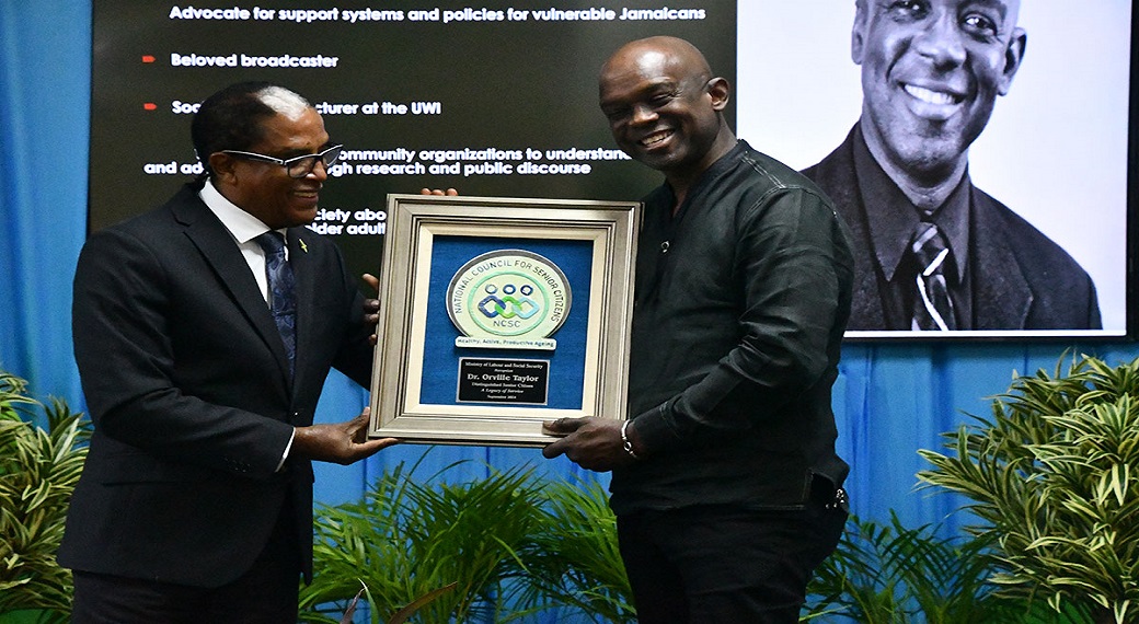 Minister of State in the Ministry of Labour and Social Security, Dr Norman Dunn (left) presents the award for Distinguished Senior Citizen to broadcaster and lecturer, Dr Orville Taylor. Occasion was the National Council for Senior Citizens (NCSC) regional awards ceremony held at the Cardiff Hotel and Spa in Runaway Bay, St. Ann, on Friday (September 27).