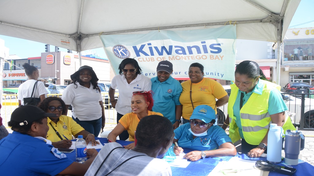 President of the Kiwanis Club of Montego Bay, Hugh Miller (standing, centre), observes as members conduct registration for the organisation’s annual Diabetes Health Fair. The event was held in Sam Sharpe Square, Montego Bay on November 2. (Photo: JIS)