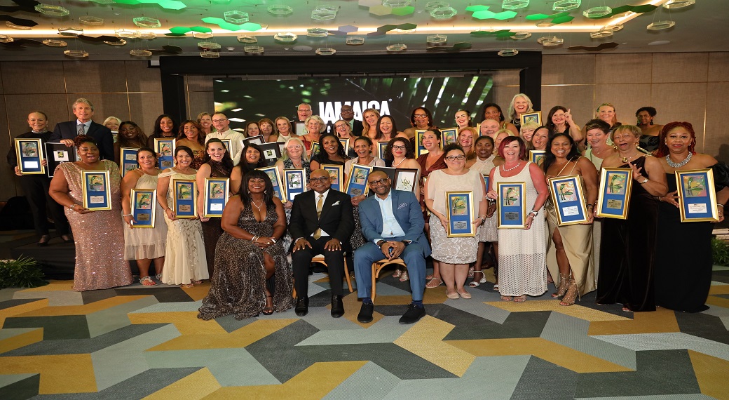 
Edmund Bartlett, Minister of Tourism (seated centre), Donovan White, Director of Tourism (right), and Angella Bennett, Regional Director for Canada at the Jamaica Tourist pose with awardees during the One Love Affair: An Eco-Chic Soiree event that celebrated the top 50 travel advisors selling Jamaica.
