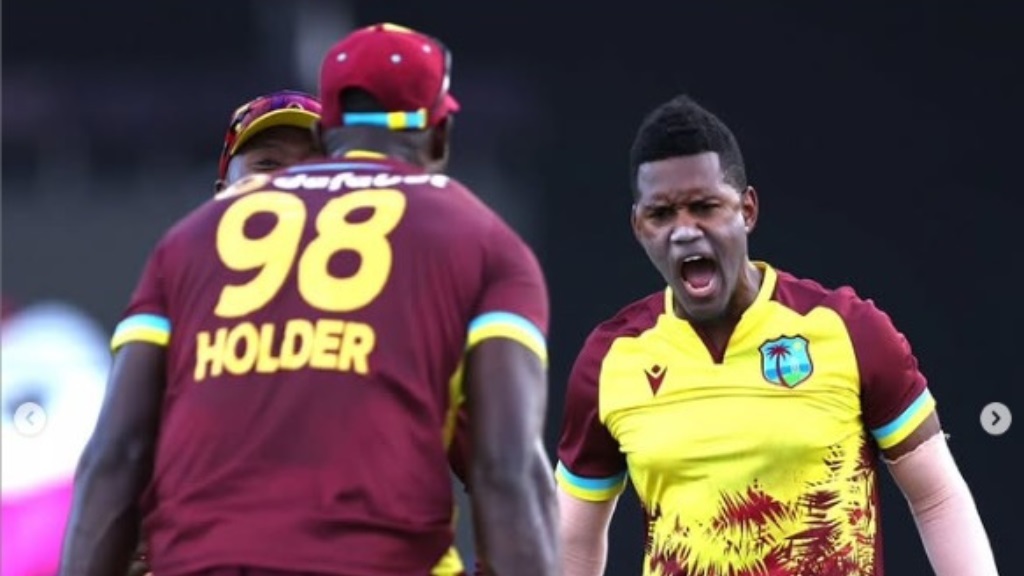 Akeal Hosein (right) celebrates with Jason Holder.