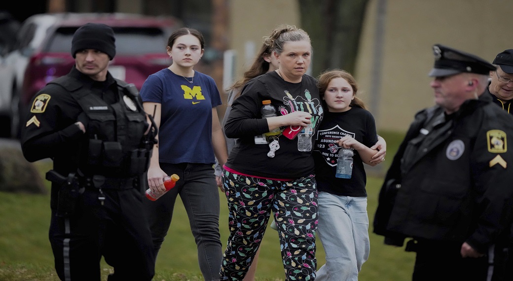 A family leaves the shelter after multiple injuries were reported following a shooting at the Abundant Life Christian School, Monday, December 16, 2024. (Photo: AP)