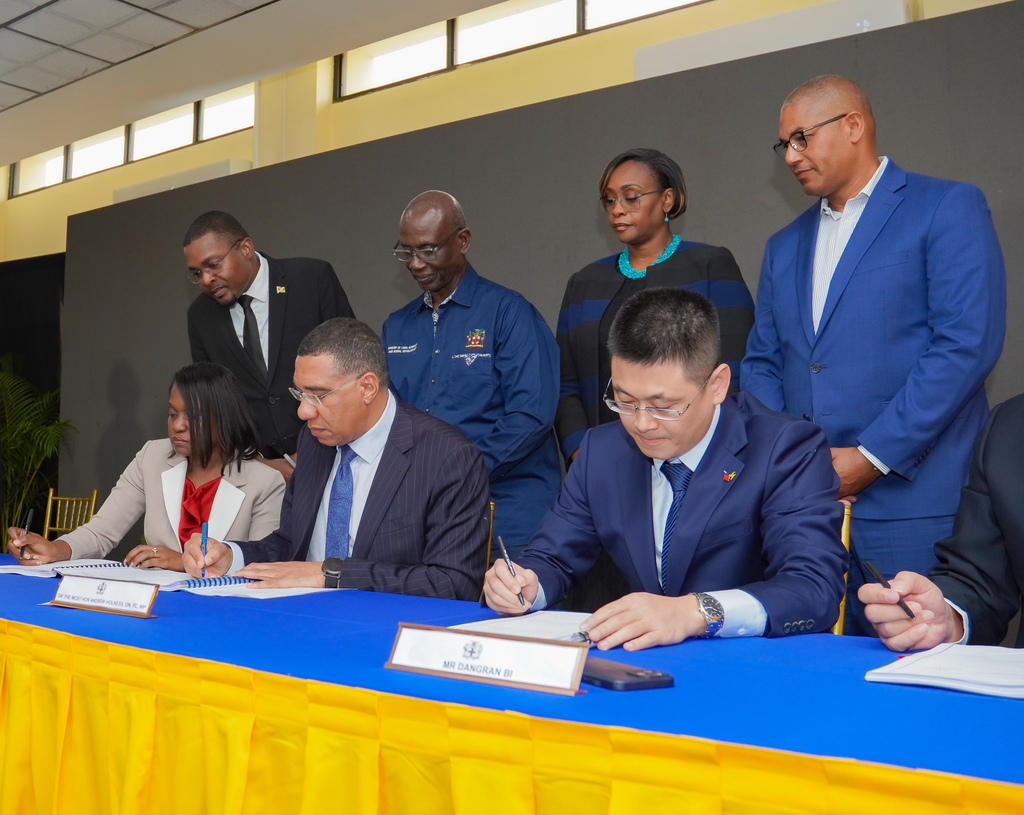 Prime Minister Dr Andrew Holness is joined by Arlene Williams, Permanent Secretary at the Ministry of Economic Growth and Dangran Bi, Country Manager at the CHEC, to sign the official contract for the SPARK programme. Also present are Robert Nesta Morgan, minister with Responsibility for Works, Desmond McKenzie, Minister of Local Government and Community Development, Juliet Holness MP for East Rural St Andrew, and Mikael Phillips Opposition Spokesperson for works.