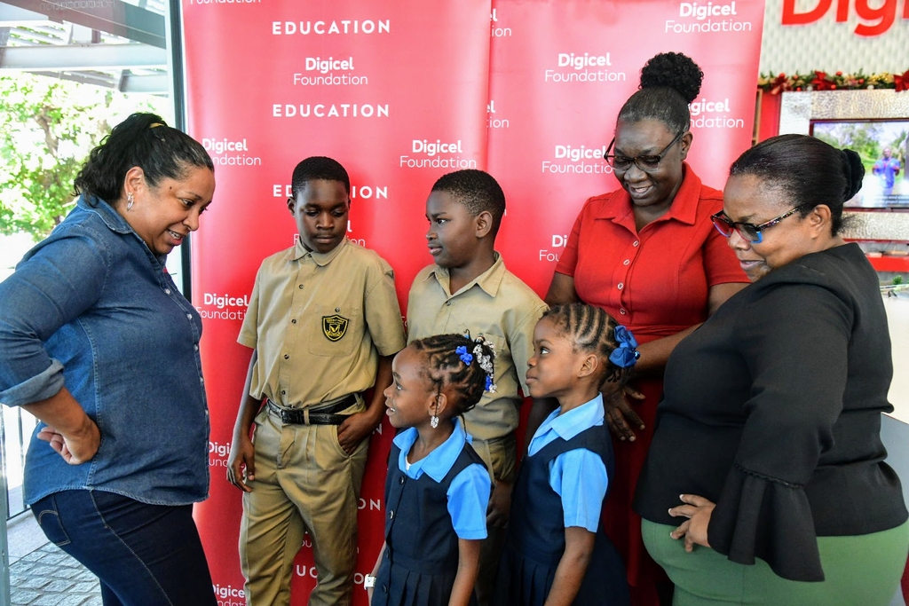 CEO of the Digicel Foundation, Charmaine Daniels (left), interacts with Principals and students during the organisation’s 20-for-20-for-20 Build Jamaica Grants handover ceremony on December 6.  From right are Principal of Salt Spring Primary and Infant School, Norma Brydson, and Principal of Prickly Pole Primary and Infant School, Judith Whyte Gayle. The students are Rickayla Warlock and Ty'aira Young of Salt Spring Primary.