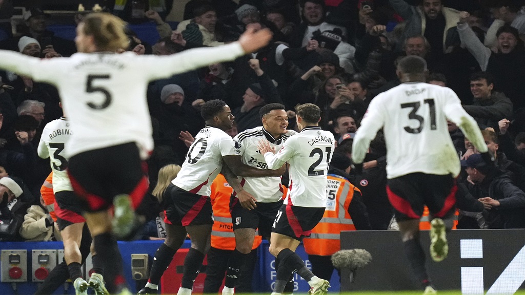 Fulham's Rodrigo Muniz, centre, celebrates after scoring his sides second goal during the English Premier League football match against Chelsea at Stamford Bridge stadium in London, Thursday, Dec. 26, 2024. (AP Photo/Kirsty Wigglesworth).