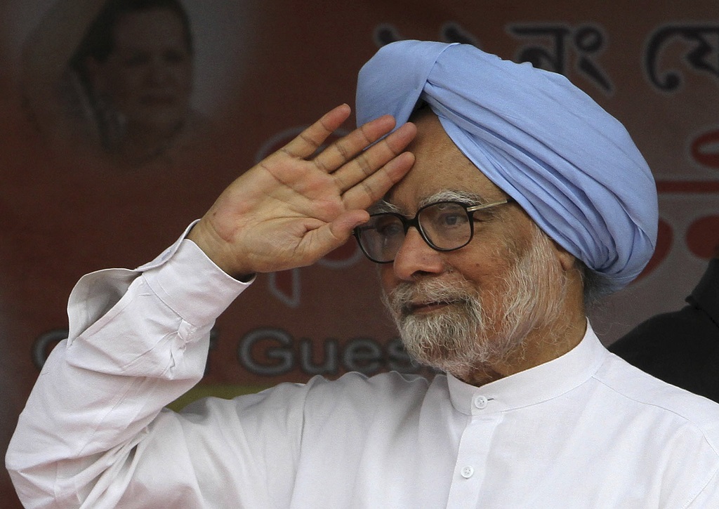 FILE - Indian Prime Minister Manmohan Singh greets the crowd during an election campaign rally at Khumtai, in the northeastern Indian state of Assam, Saturday, March 29, 2014. (AP Photo/Anupam Nath, File)
