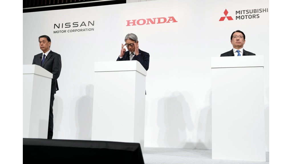 Nissan Chief Executive Makoto Uchida, left, and Honda Chief Executive Toshihiro Mibe, center, and Takao Kato CEO of Mitsubishi Motors, right, attend a joint news conference Monday, December 23, 2024, in Tokyo, Japan. (AP Photo/Eugene Hoshiko)
