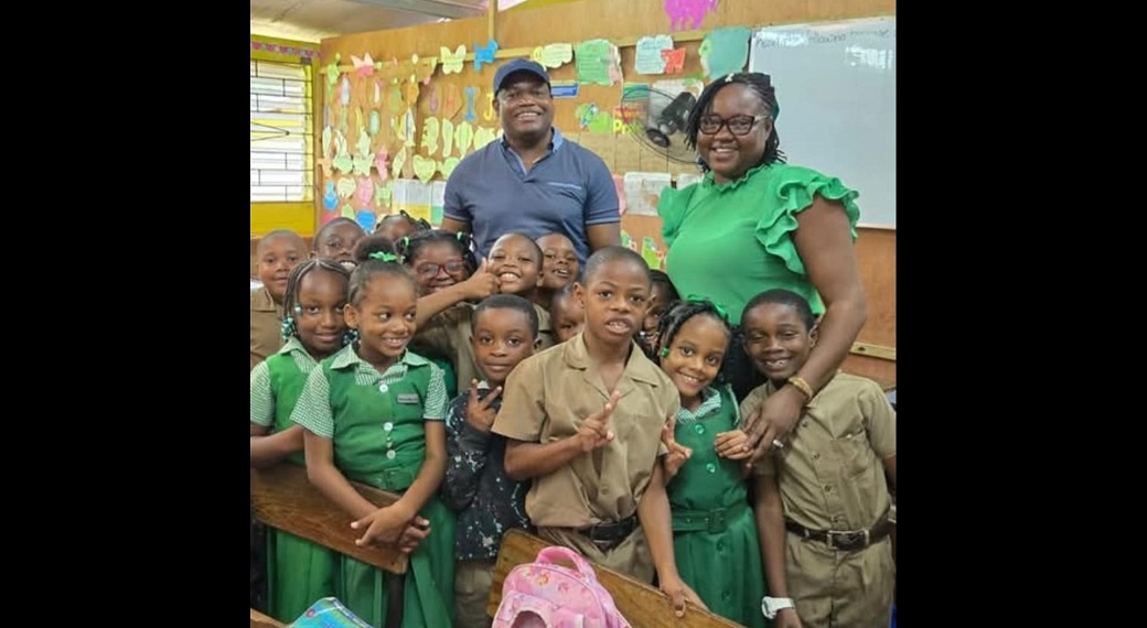 Paul Miles poses with teacher Mrs McIntosh Bailey at Petersville Primary School where he donated 140 chrome books.